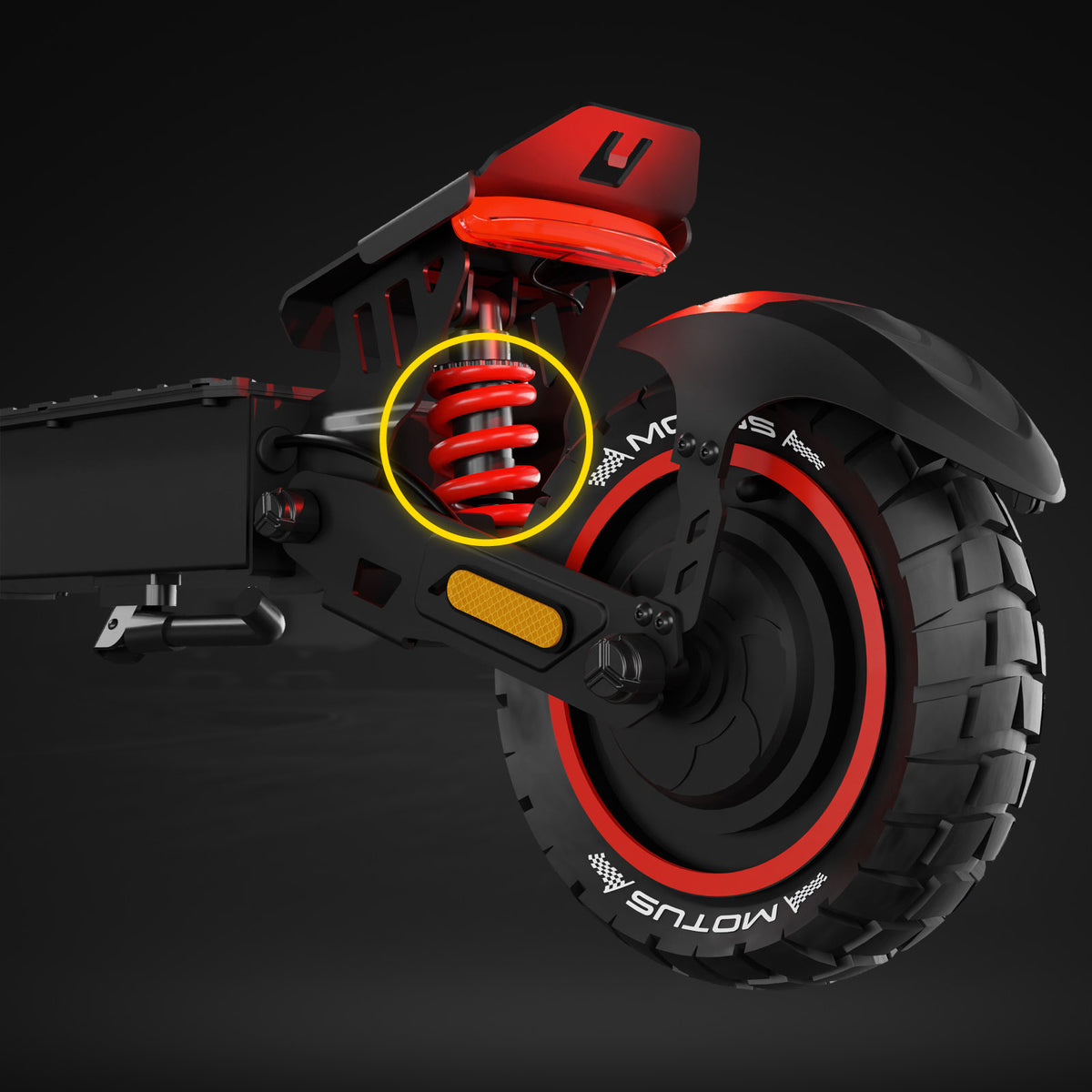 Tylne koło MOTUS Daytona 10 Max z czerwoną sprężyną amortyzatora zaznaczoną żółtym pierścieniem, ciemne tło.