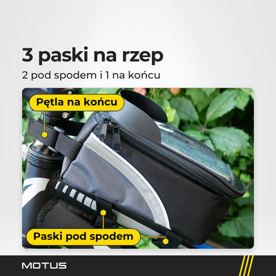 Torba rowerowa na ramę MOTUS na rowerze: 2 paski na rzep pod spodem obejmują ramę, a pętla na końcu zapina się przy kierownicy.